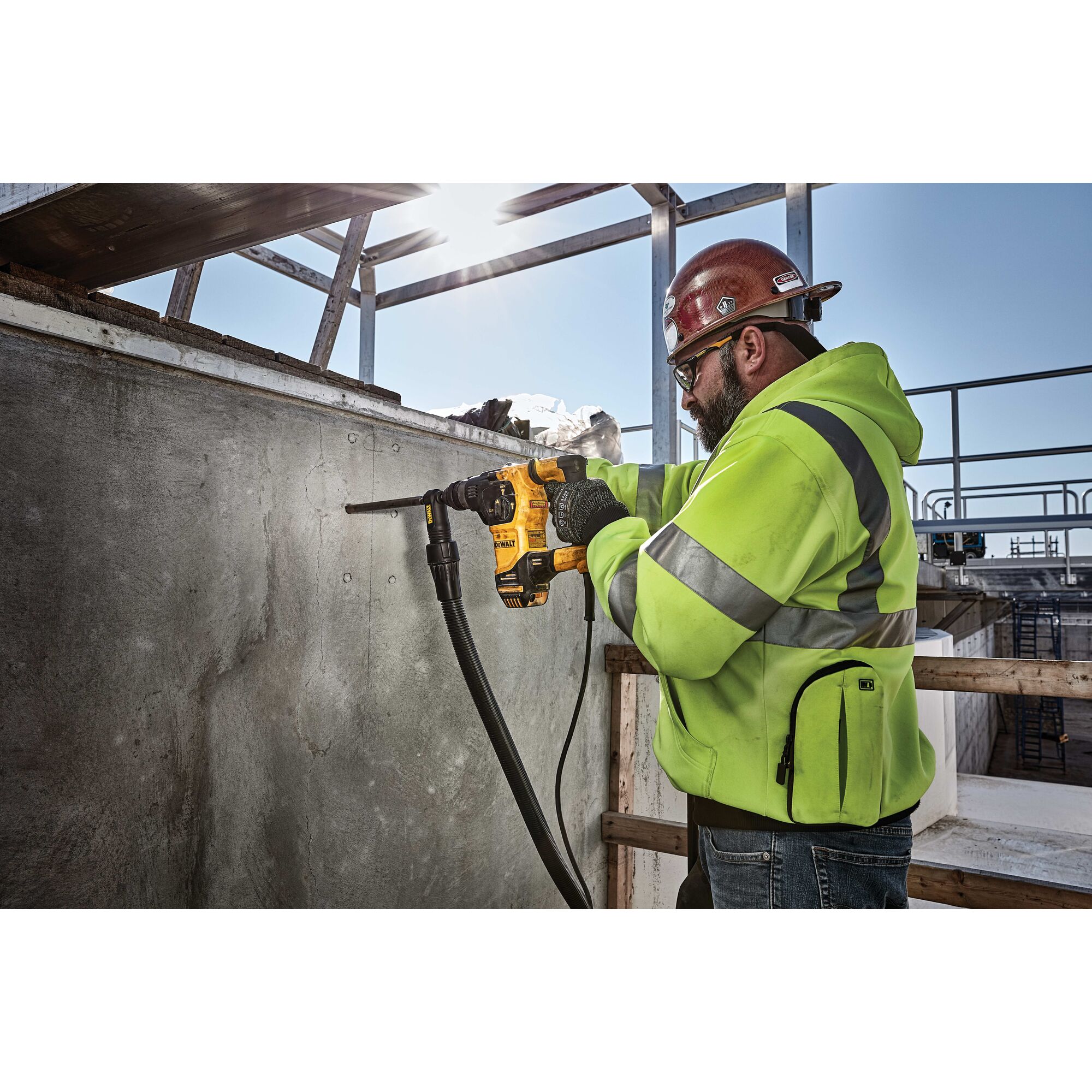 Profile of SDS Plus rotary hammer with dust extractor being used by person