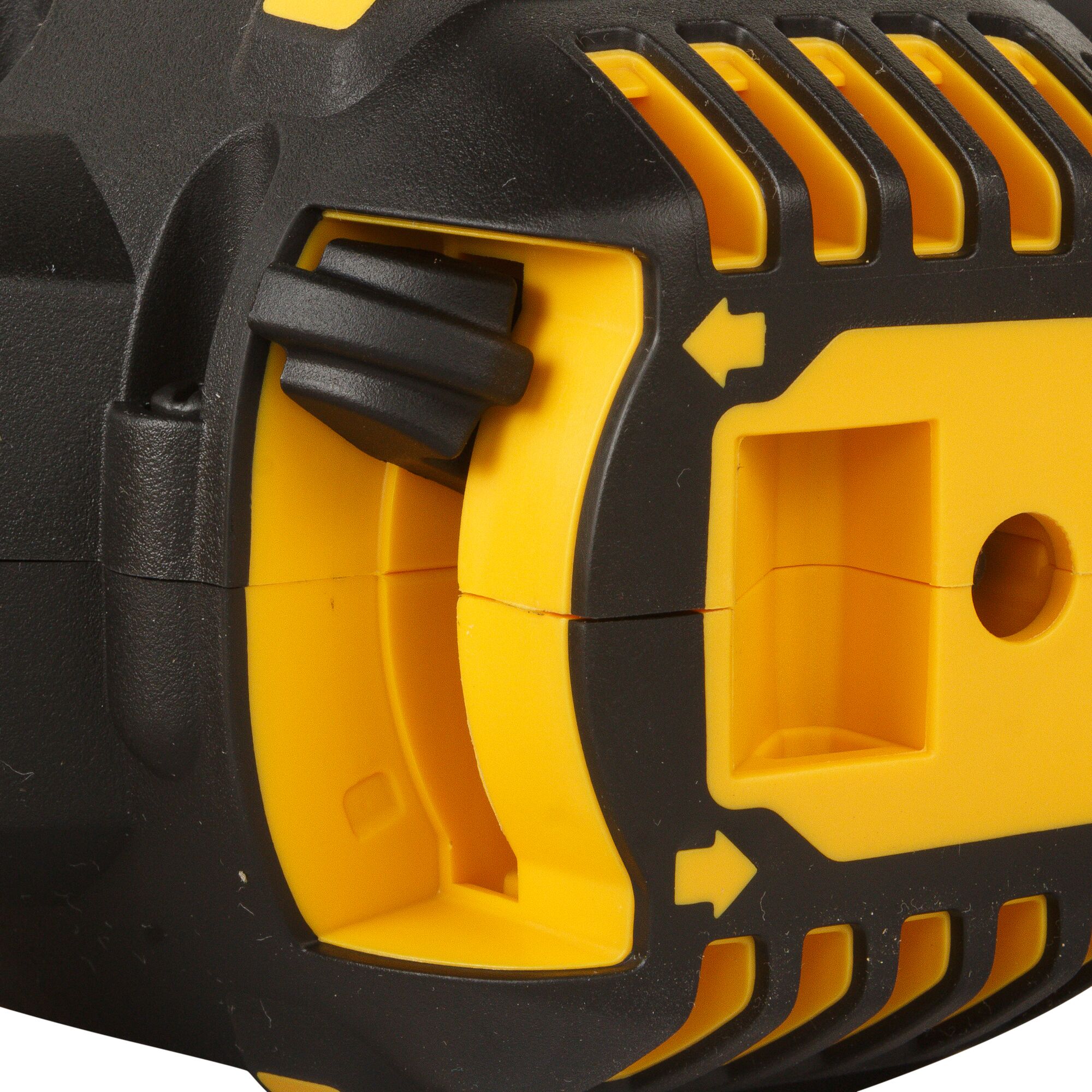 Close-up view of a DEWALT power tool, showing a yellow and black plastic housing with vent grooves, a ridged control switch, and an arrow indicator.