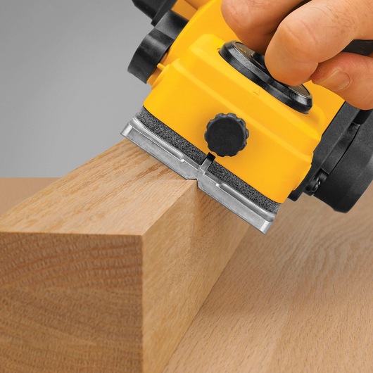 DEWALT Portable Hand Planer being used by a person to even out a wooden edge