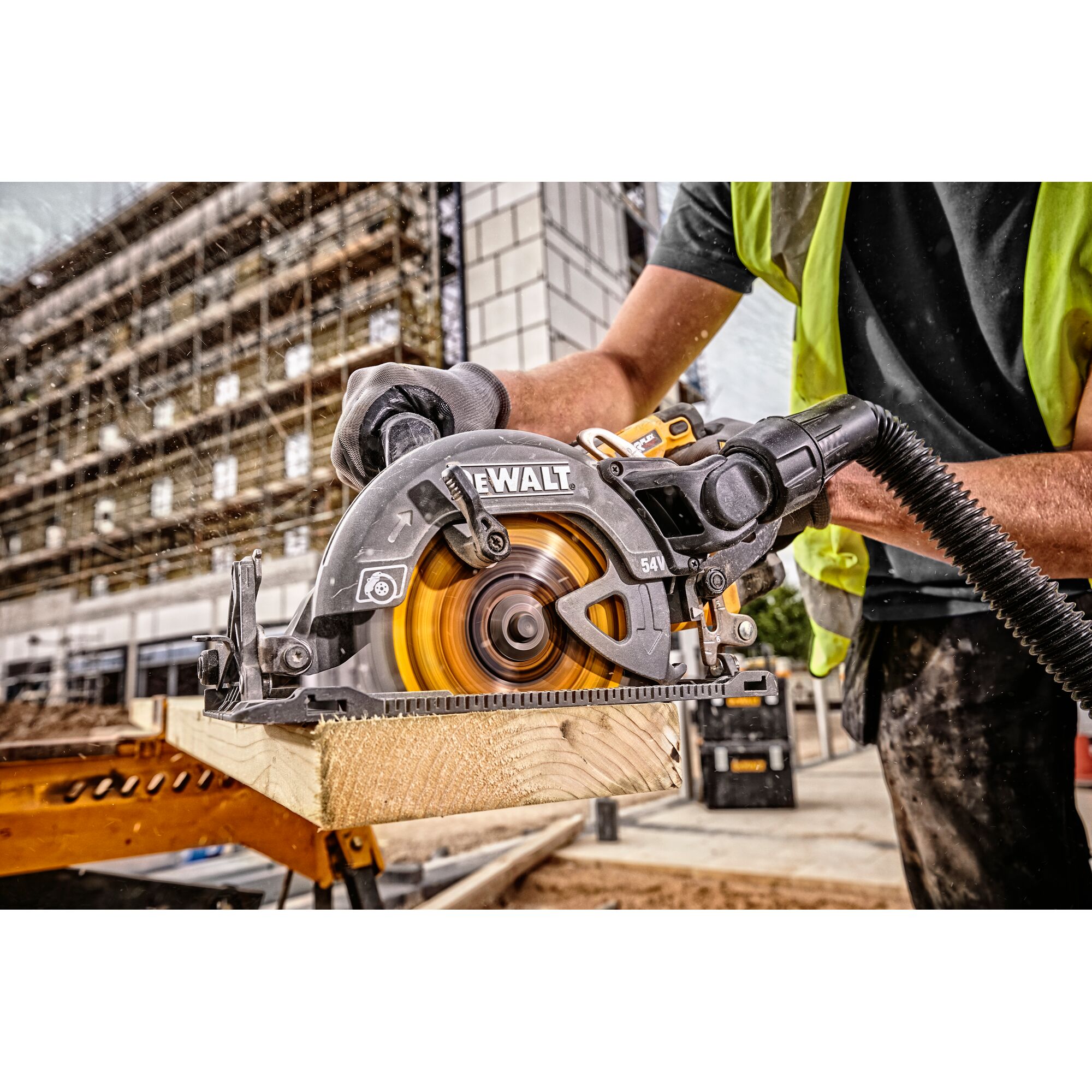DEWALT circular saw cutting wood on a construction site, operated by a worker in safety gear.