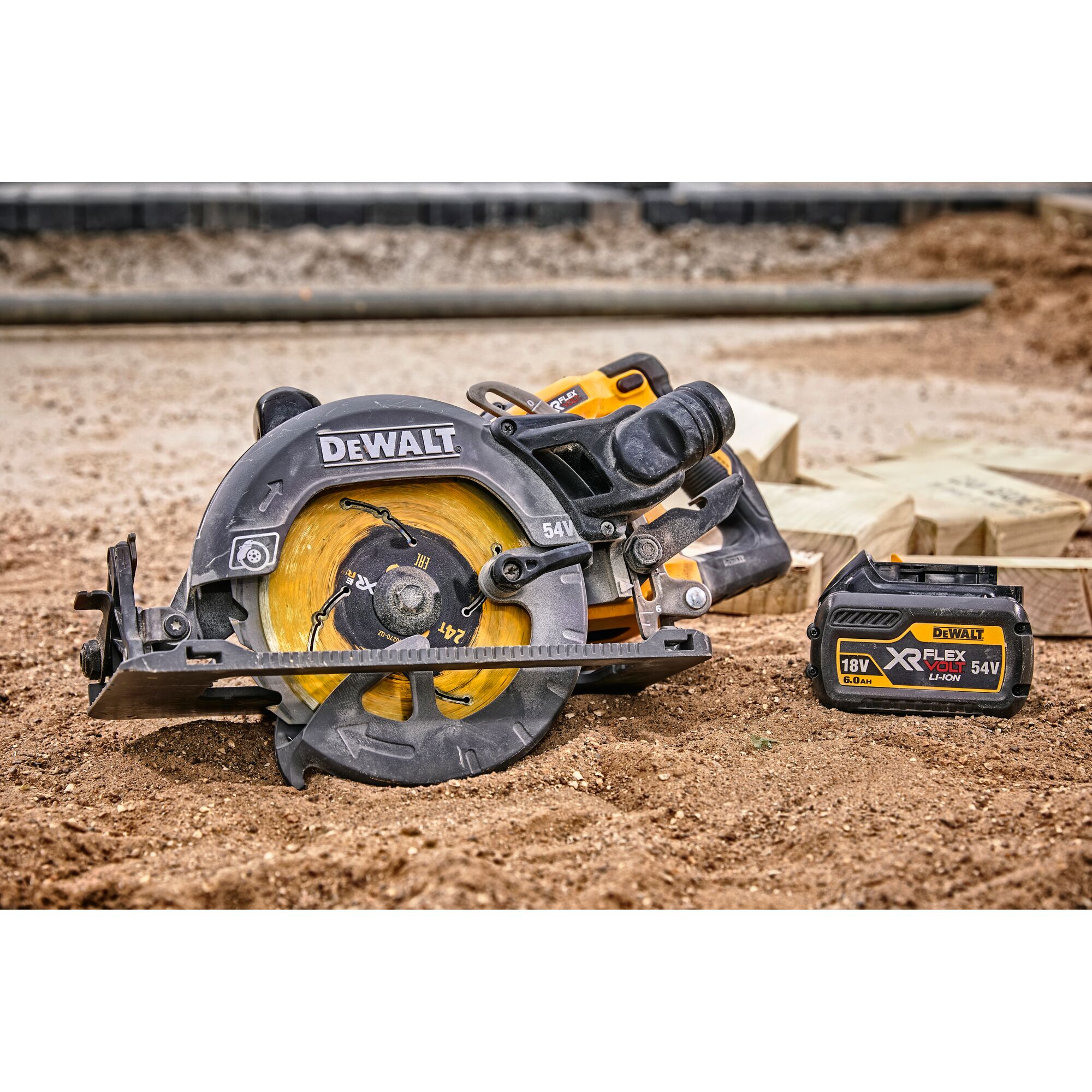 DEWALT cordless circular saw and battery on dirt, with wooden planks in background.
