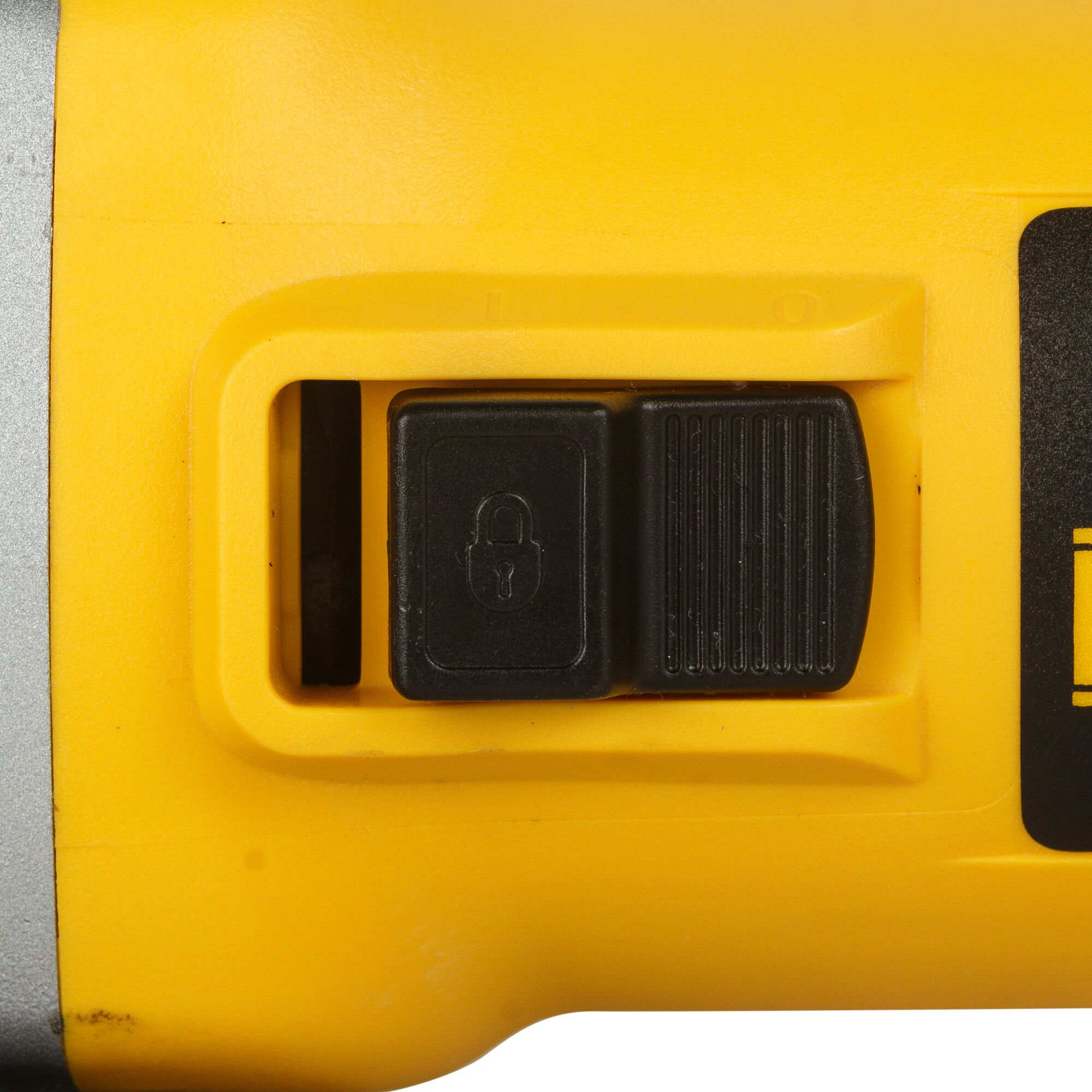Close-up view of a yellow DEWALT power tool showing a black lock switch and slider control.