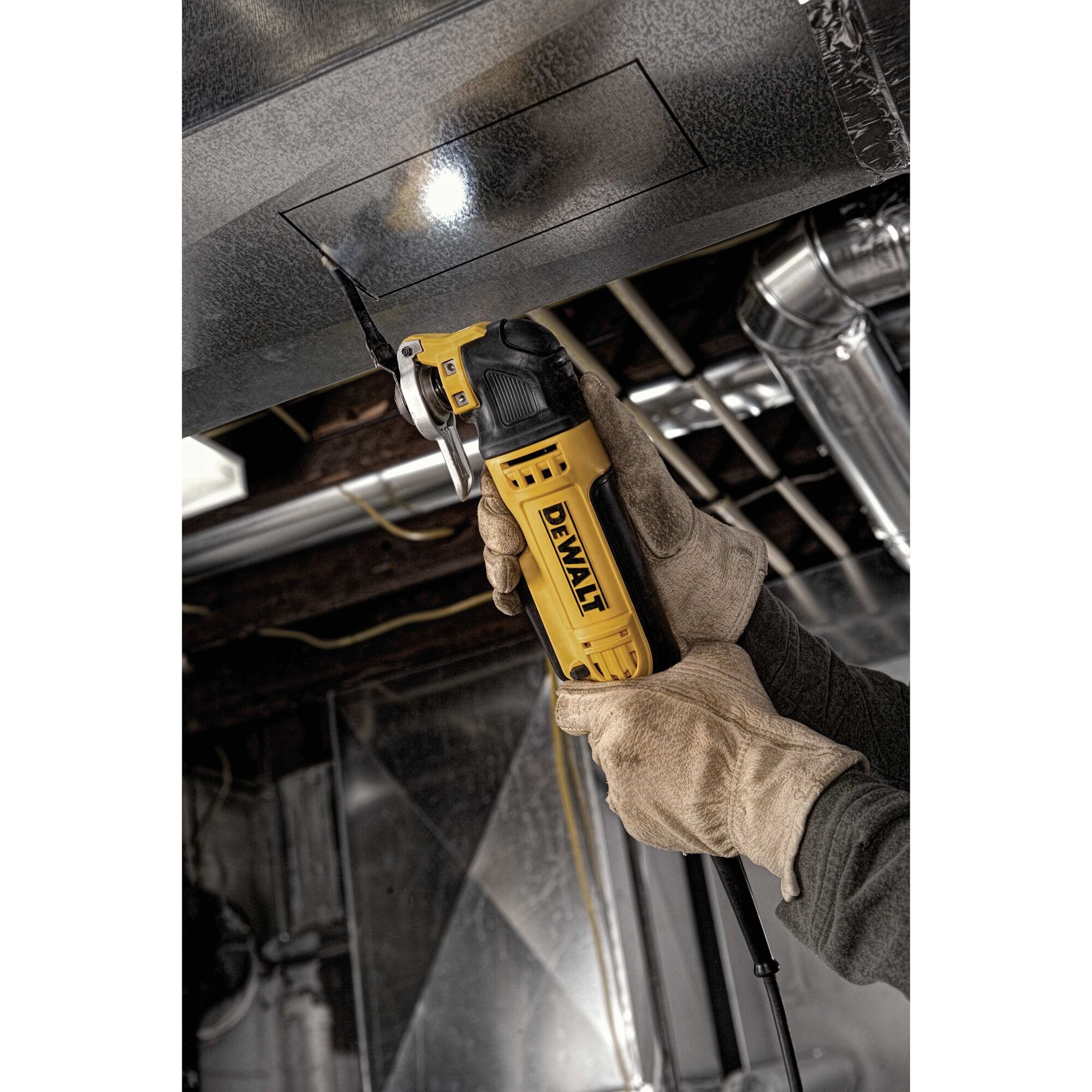 Oscillating multi tool kit being used to cut metal.