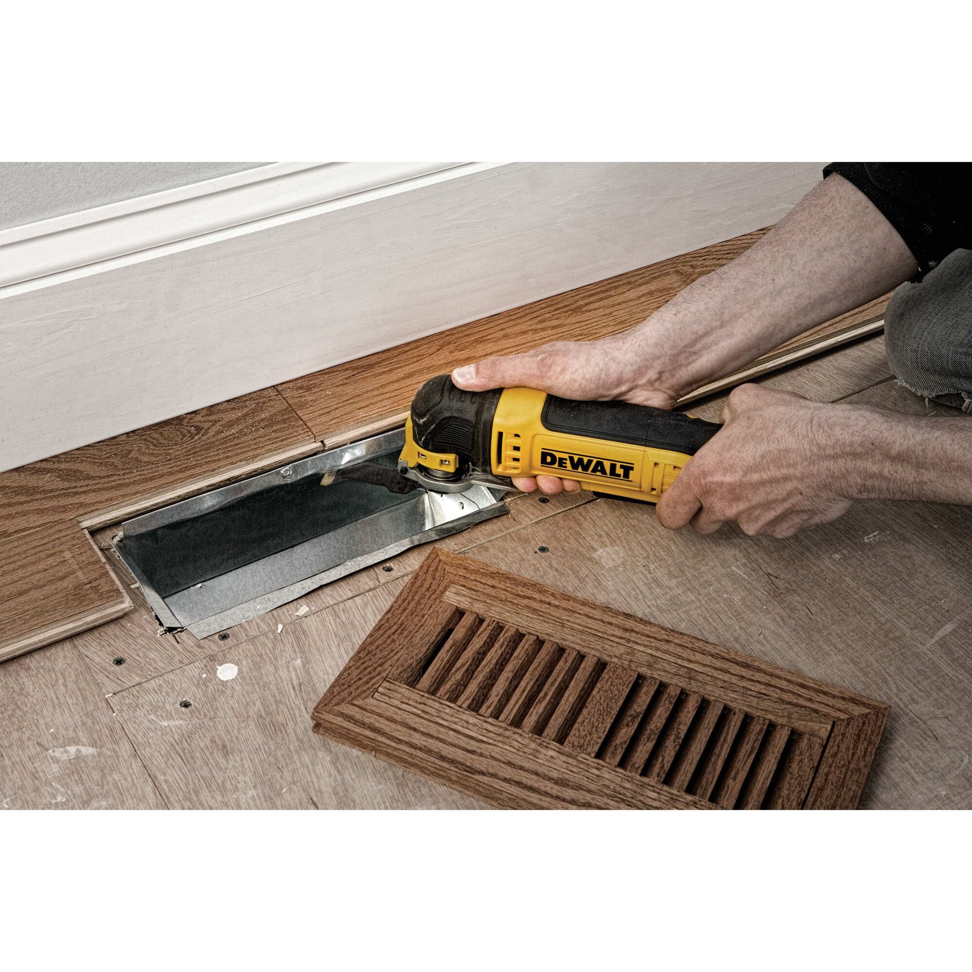 Oscillating multi tool kit being used to cut metal.