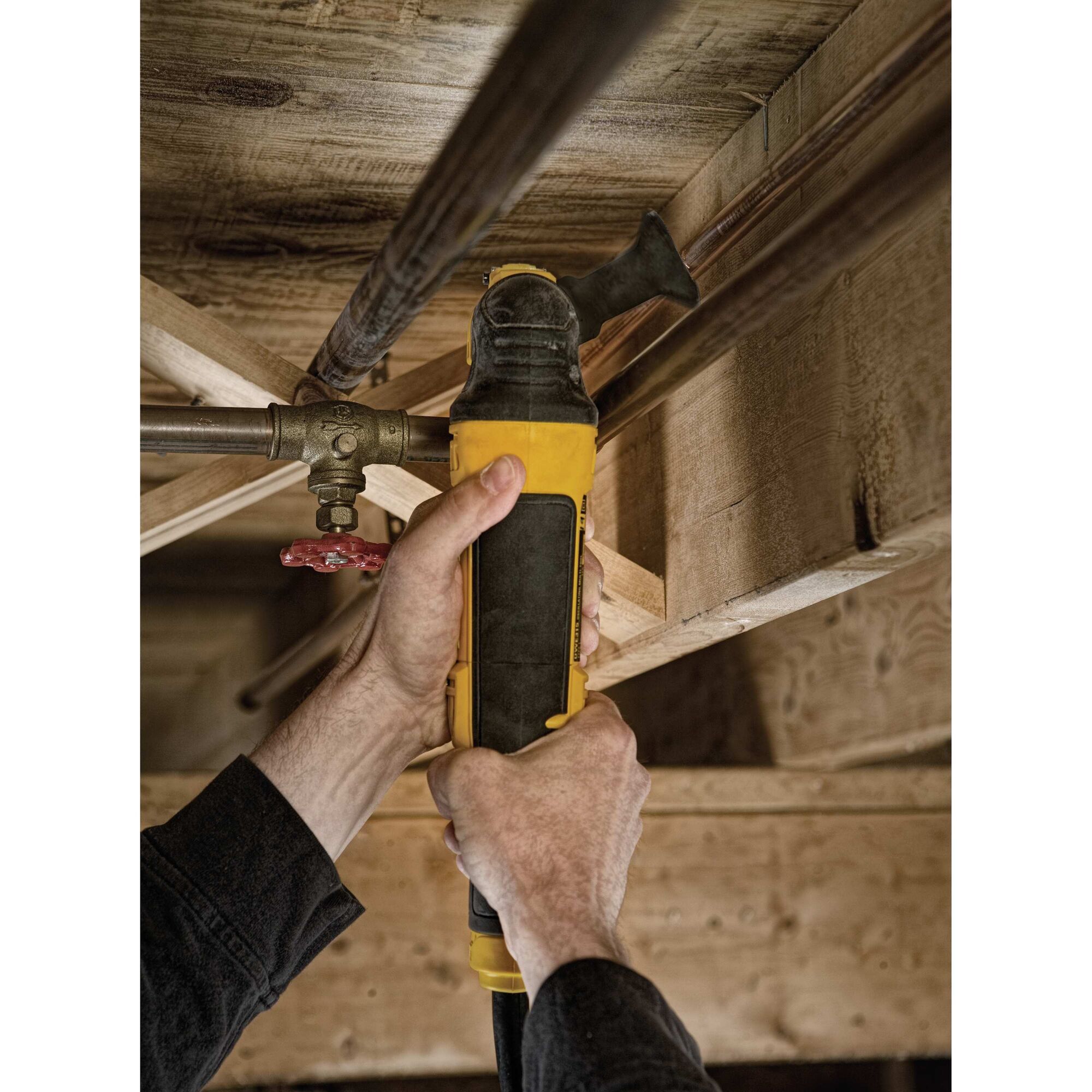 Oscillating multi tool kit being used to sand wood.