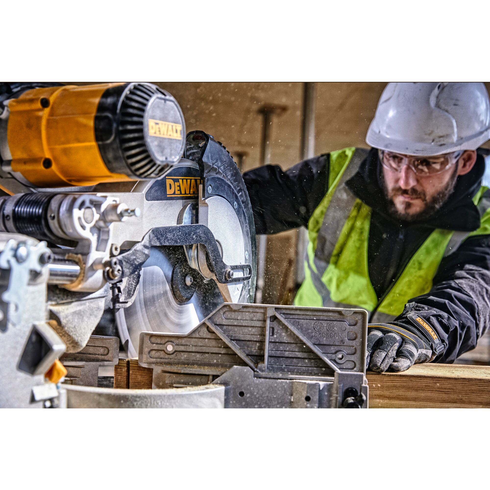 12 inch double bevel sliding compound miter saw cutting a wooden panel.