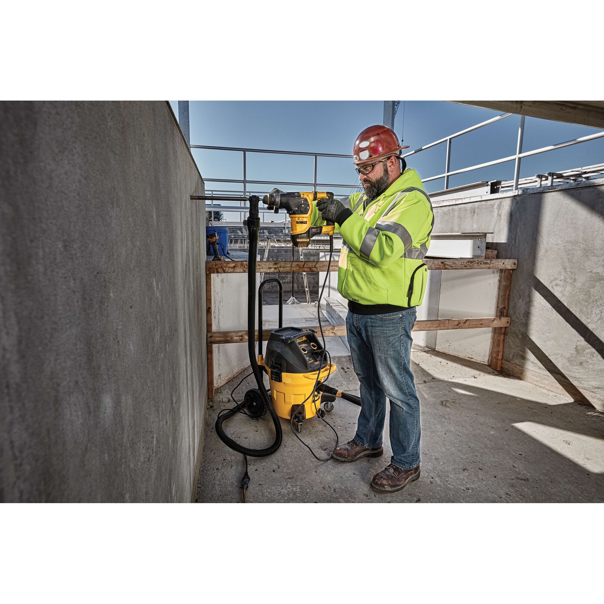 Profile of SDS Plus rotary hammer with dust extractor being used by person