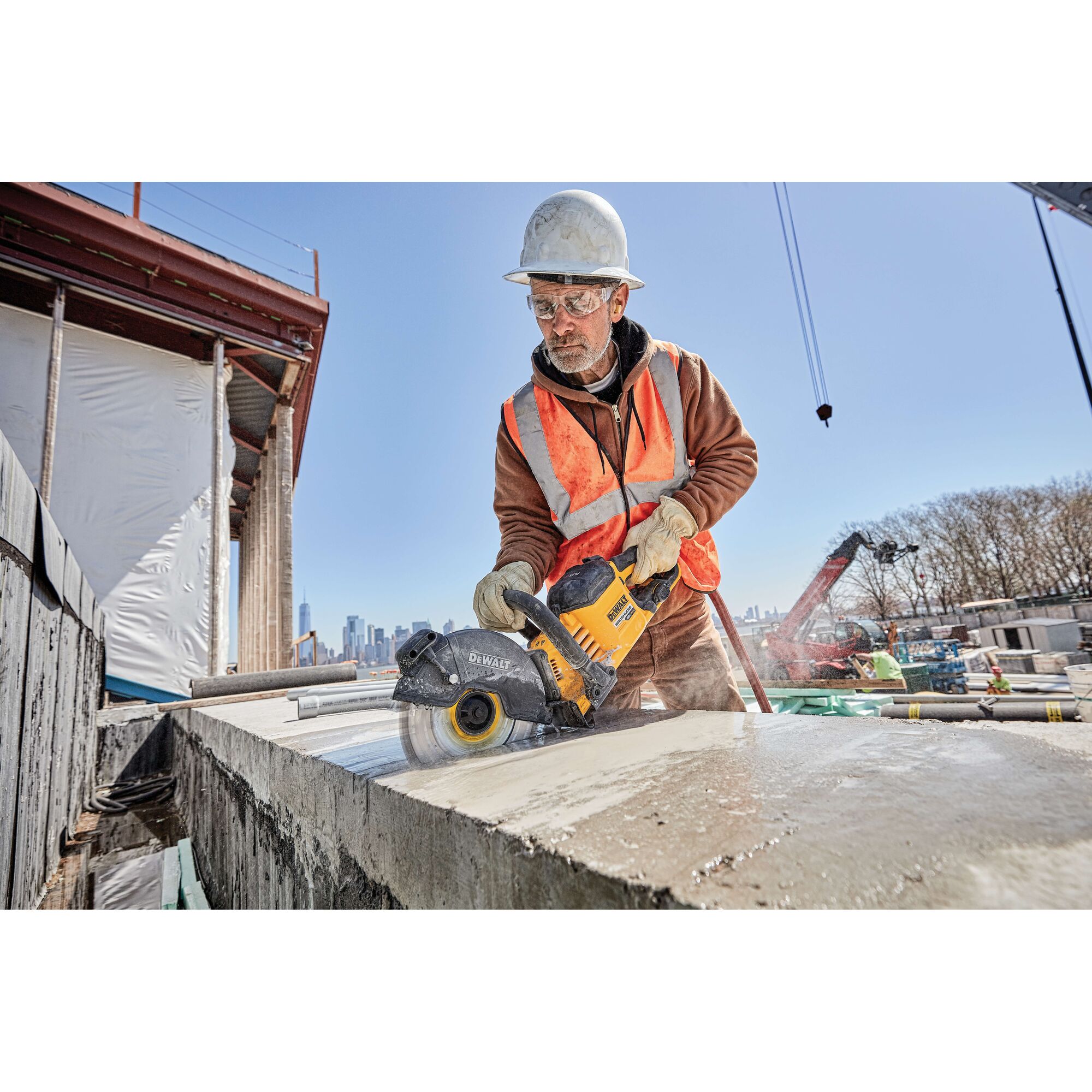 20 Volt to 60 Volt 12 AMP hours Lithium Ion Battery powered Circular Saw being used by a construction worker to cut concrete at a construction site