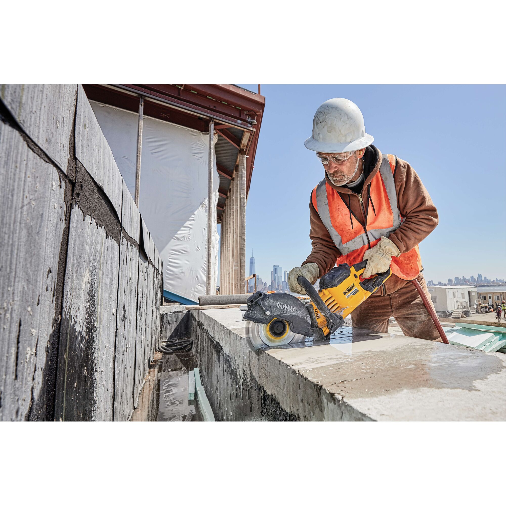 20 Volt to 60 Volt 12 AMP hours Lithium Ion Battery powered Circular Saw being used by a construction worker to cut concrete at a construction site